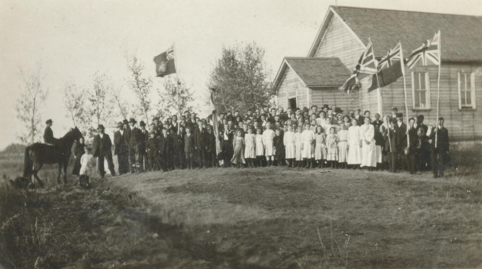 School photograph, students and parents, union jack flag, flags, dresses and suits, special occasion,  SASKATCHEWAN, CANADA